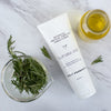 Botanical Protein Complex Conditioner white tube on marble surface with rosemary and oils