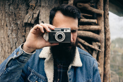 bearded man holding camera